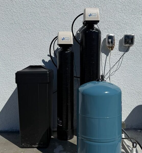 Residential water softener with black and blue tanks