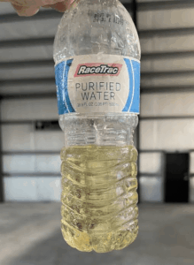 RaceTrac purified water bottle with yellow liquid